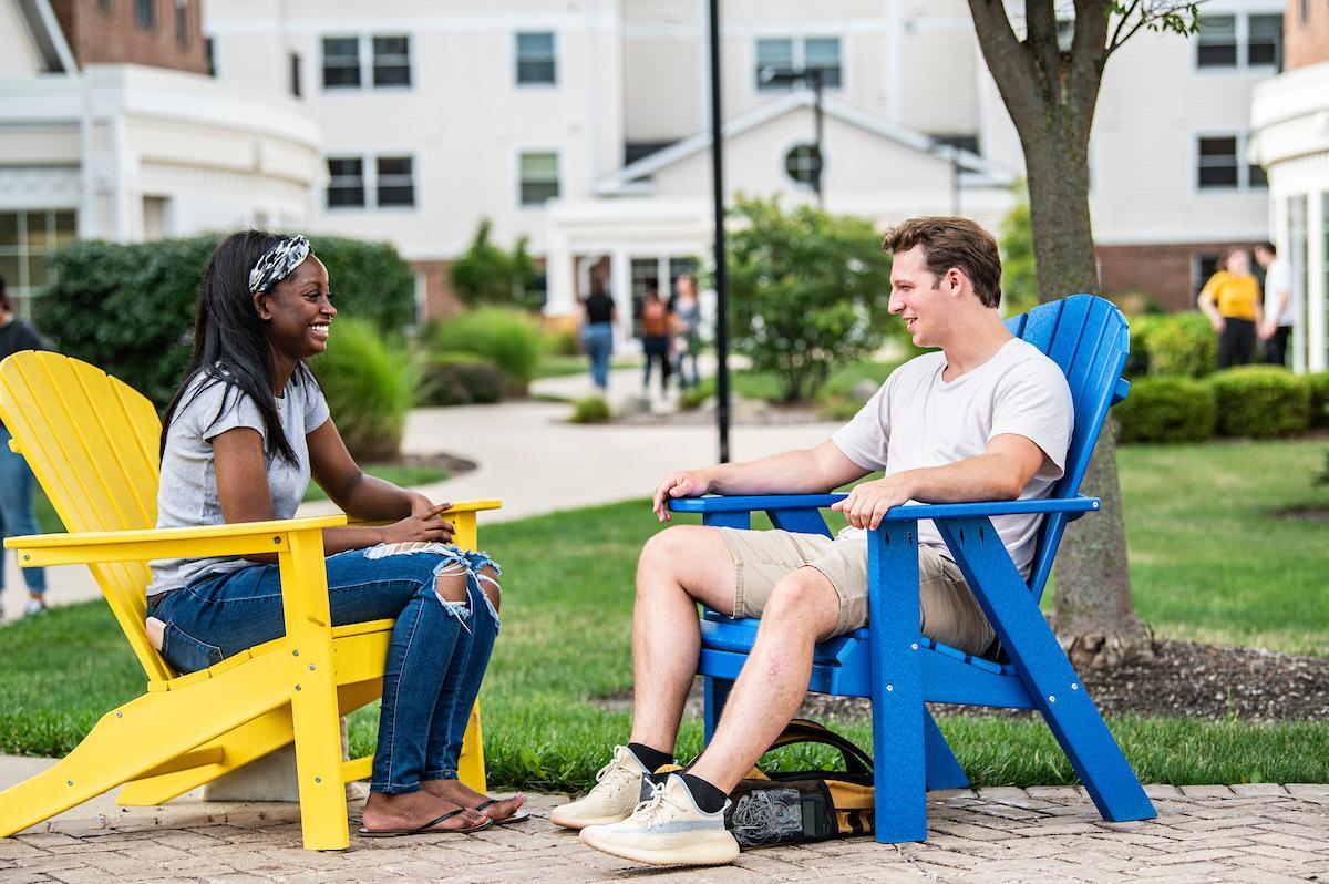 students sitting in colorful chairs